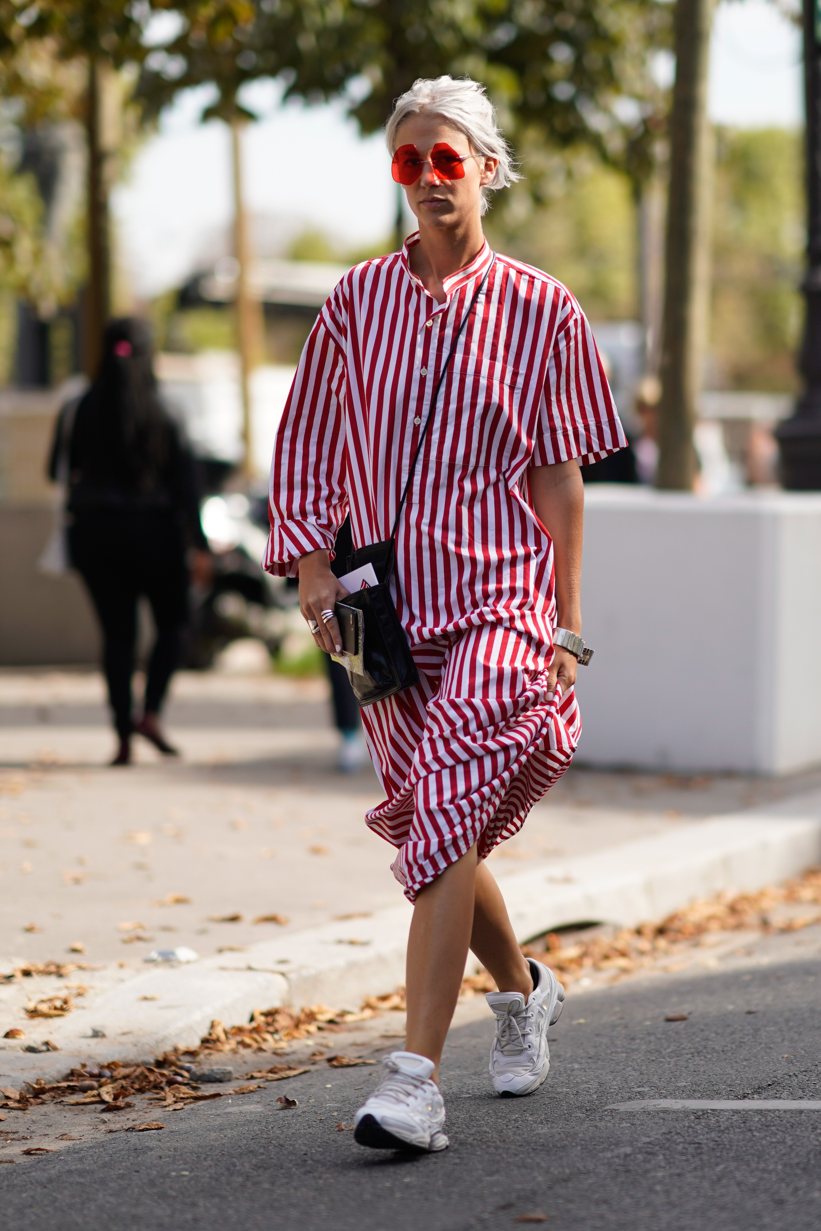 PARIS, FRANCE - SEPTEMBER 29: A guest wears a white and red striped dress, outside Issey Miyake, during Paris Fashion Week Womenswear Spring/Summer 2018, on September 29, 2017 in Paris, France. (Photo by Edward Berthelot/Getty Images)
