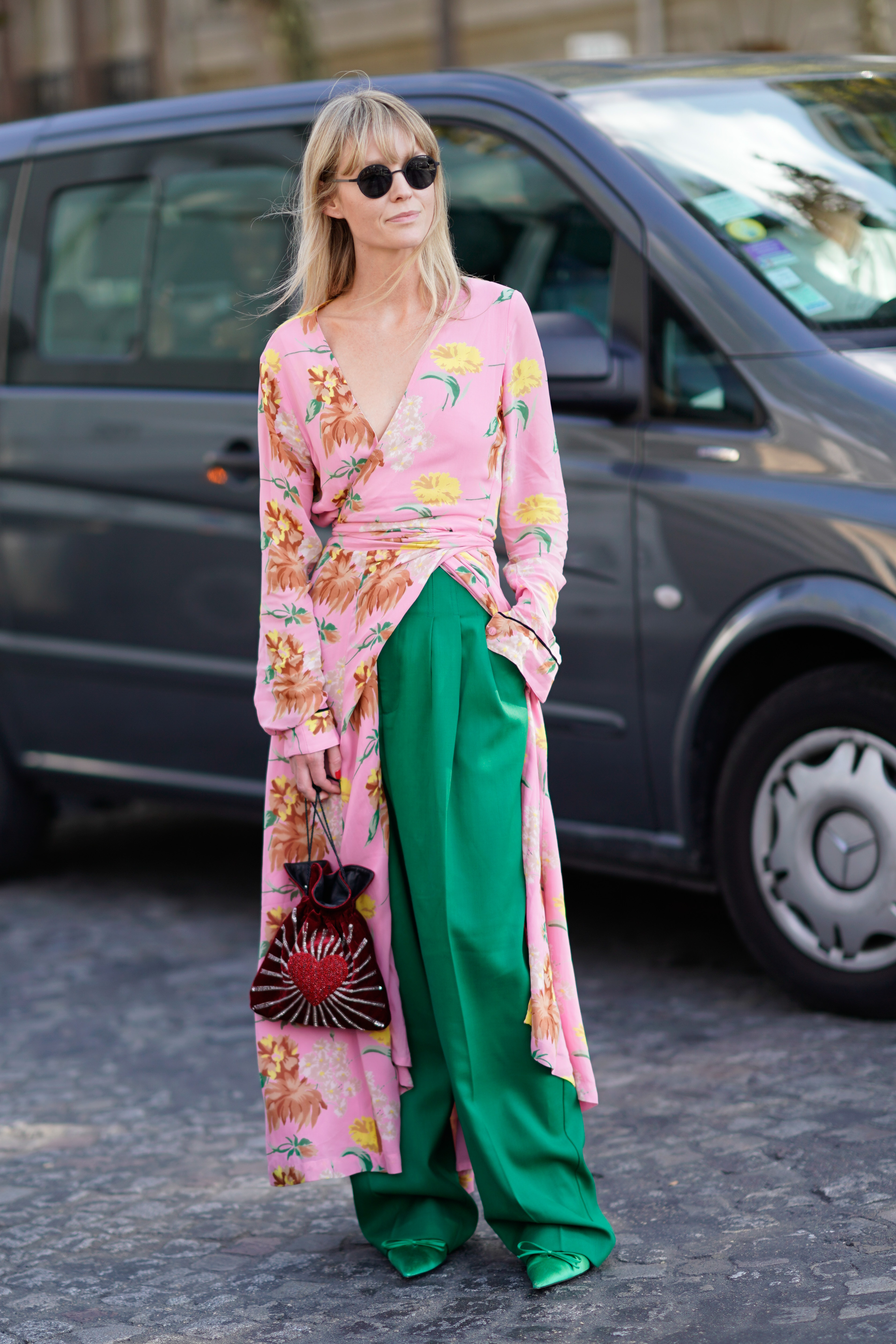 PARIS, FRANCE - SEPTEMBER 29: A guest wears a floral print kimono dress, green pants, outside Nina Ricci, during Paris Fashion Week Womenswear Spring/Summer 2018, on September 29, 2017 in Paris, France. (Photo by Edward Berthelot/Getty Images For Nina Ricci)