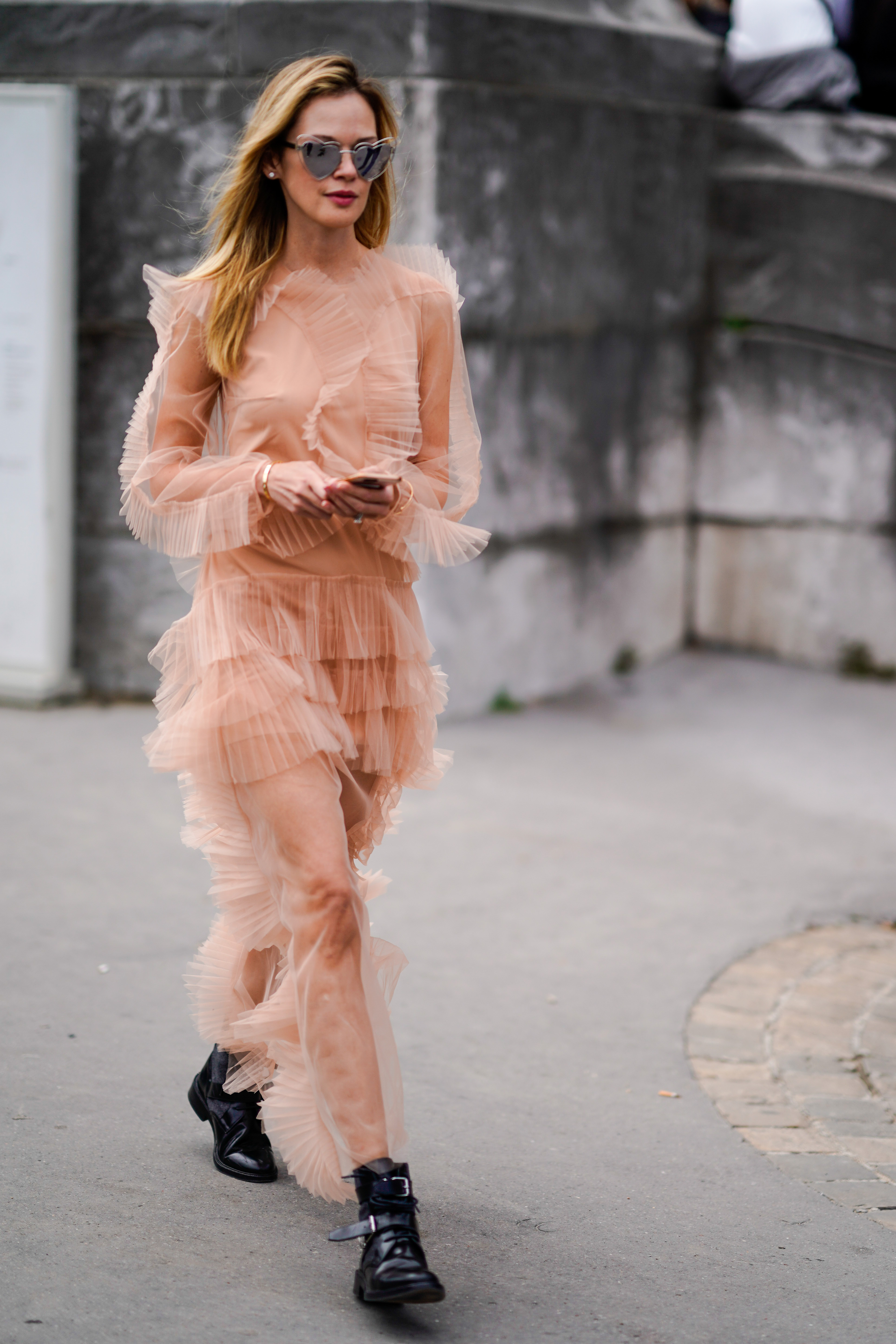 PARIS, FRANCE - SEPTEMBER 30: A guest wears a pink lace dress mesh, outside Elie Saab, during Paris Fashion Week Womenswear Spring/Summer 2018, on September 30, 2017 in Paris, France. (Photo by Edward Berthelot/Getty Images)