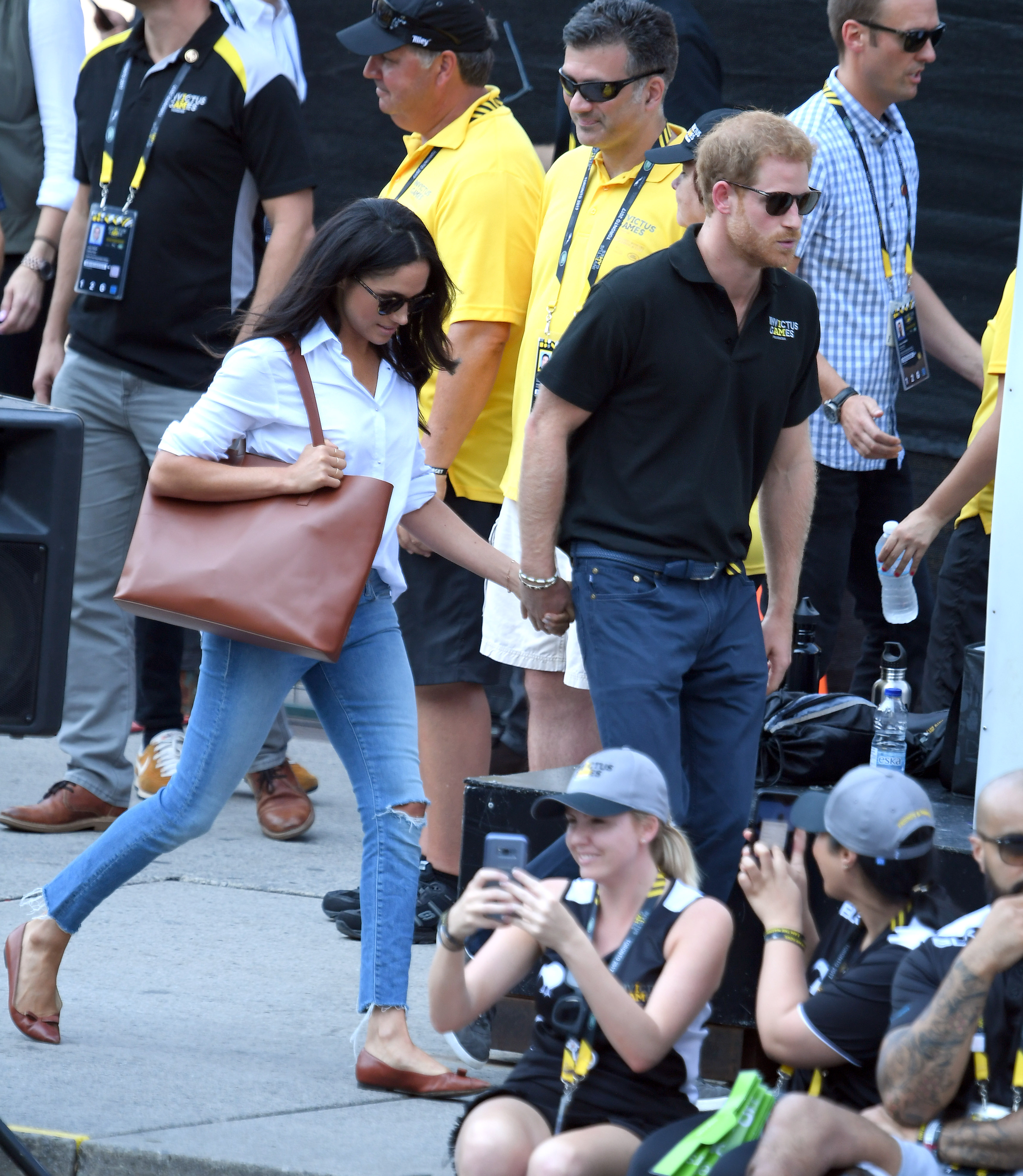 TORONTO, ON - SEPTEMBER 25: Meghan Markle and Prince Harry hold hands the Wheelchair Tennis on day 3 of the Invictus Games Toronto 2017 at Nathan Philips Square on September 25, 2017 in Toronto, Canada. The Games use the power of sport to inspire recovery, support rehabilitation and generate a wider understanding and respect for the Armed Forces. (Photo by Karwai Tang/WireImage)