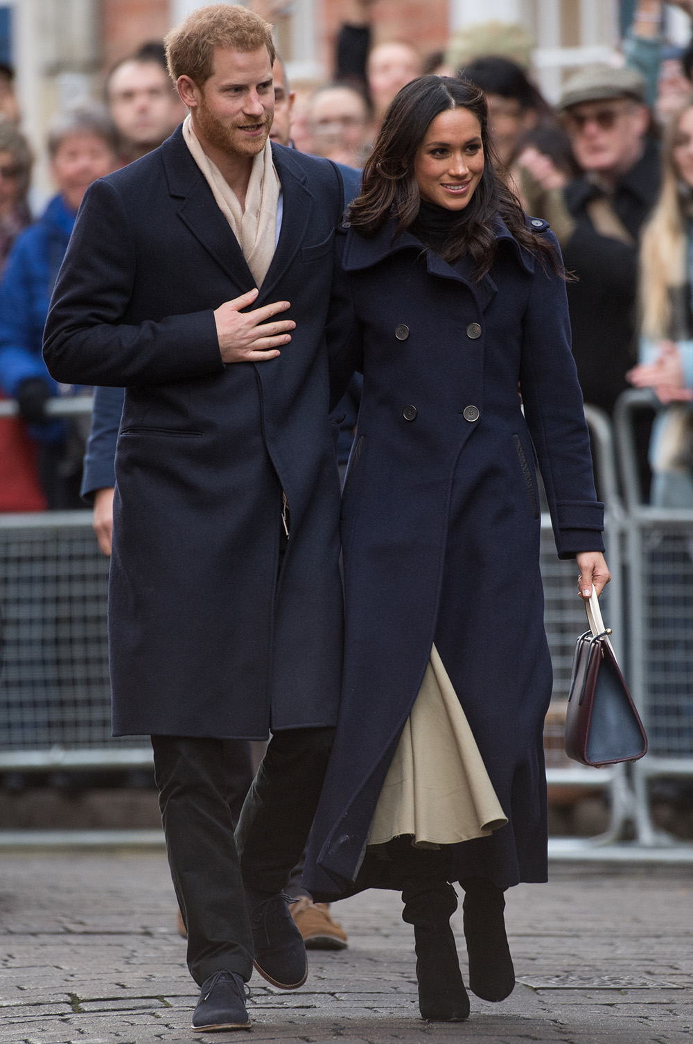 December 1, 2017: Looking chic and understated, Meghan wears a full-length cashmere mix double-breatsed navy coat from Canadian brand, Mackage, a beige Joseph skirt, burgundy tote bag from Scottish designer Strathberry and Kurt Geiger scrunch boots. Prince Harry and fiancee Meghan Markle attend the Terrence Higgins Trust World AIDS Day charity fair at Nottingham Contemporary in Nottingham, England