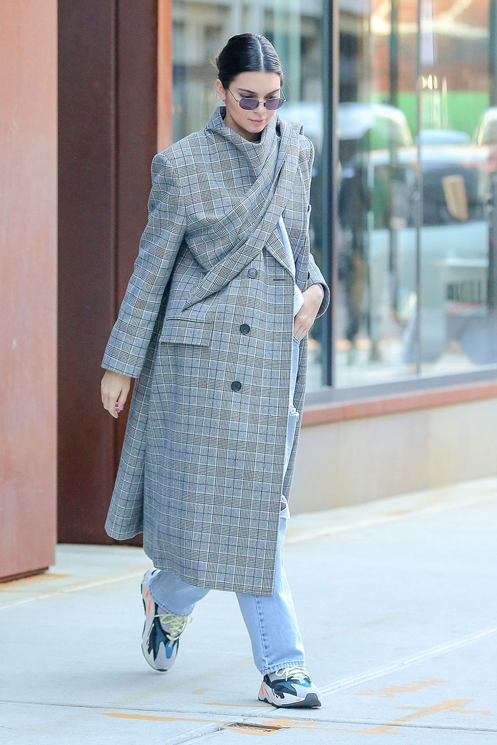 The queen of cool, Kendall Jenner, took to the streets in a beautiful plaid Balenciaga coat with scarf wrap detailing and sneans to complete the look.