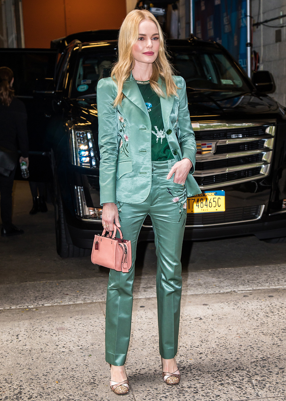 A beautiful emerald green silk suit from Coach 1941 paired with a Coach bag and shoes.