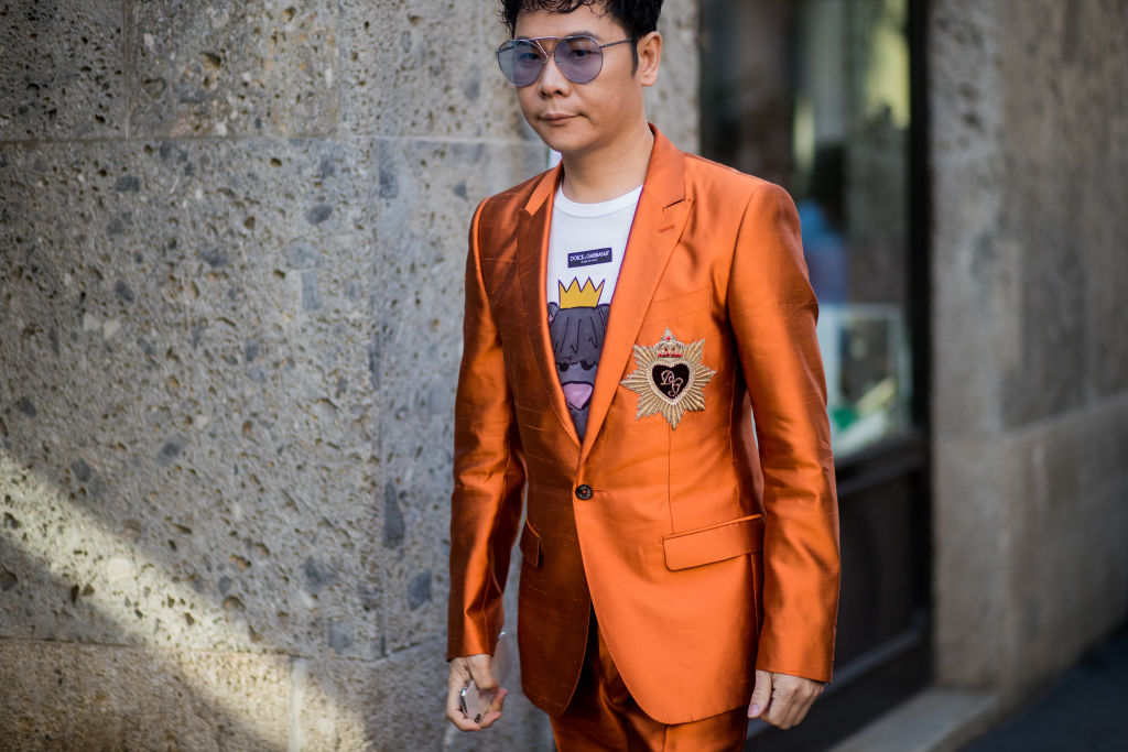 MILAN, ITALY - JANUARY 13: A guest wearing orange suit is seen outside Dolce & Gabbana during Milan Men's Fashion Week Fall/Winter 2018/19 on January 13, 2018 in Milan, Italy. (Photo by Christian Vierig/Getty Images)