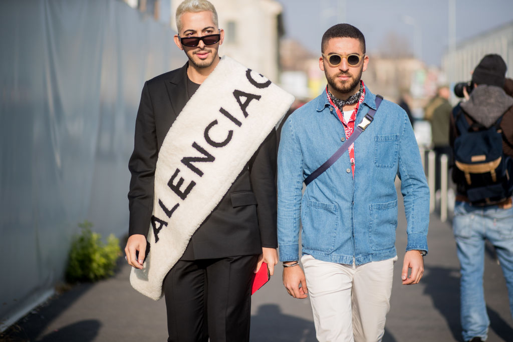 MILAN, ITALY - JANUARY 14: A guest wearing Balenciaga scarf and a guest wearing denim jacket is seen outside DSquared2 during Milan Men's Fashion Week Fall/Winter 2018/19 on January 14, 2018 in Milan, Italy. (Photo by Christian Vierig/Getty Images)