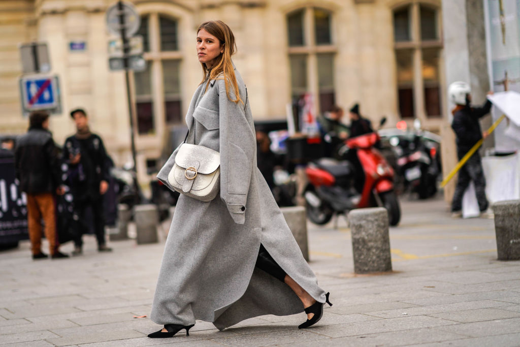 PARIS, FRANCE - JANUARY 24: A guest wears a gray oversized coat, a bag, outside Viktor & Rolf, during Paris Fashion Week -Haute Couture Spring/Summer 2018, on January 24, 2018 in Paris, France. (Photo by Edward Berthelot/Getty Images)