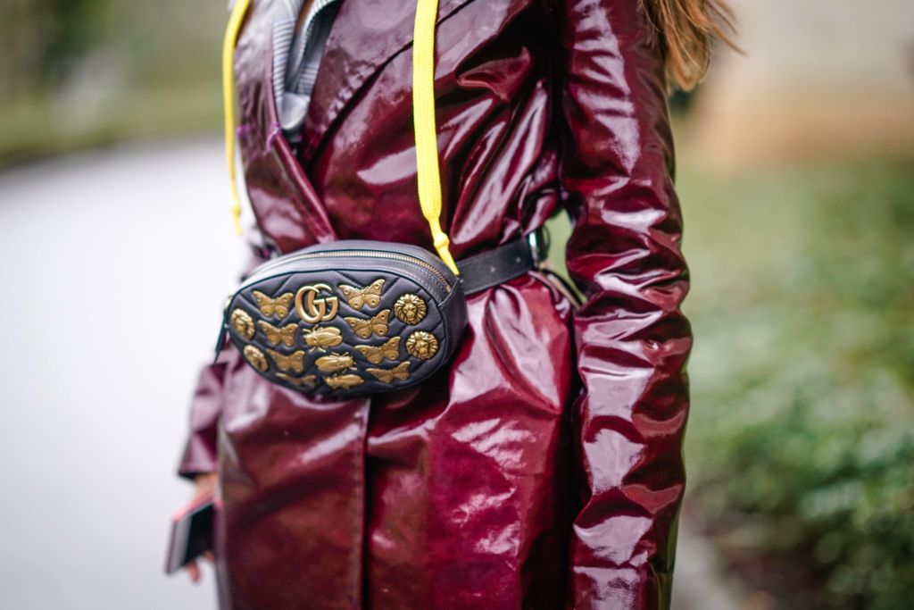 PARIS, FRANCE - JANUARY 25: A guest wears a red leather shniy trench coat, a Gucci belt bag, outside Christophe Josse, during Paris Fashion Week -Haute Couture Spring/Summer 2018, on January 25, 2018 in Paris, France. (Photo by Edward Berthelot/Getty Images)