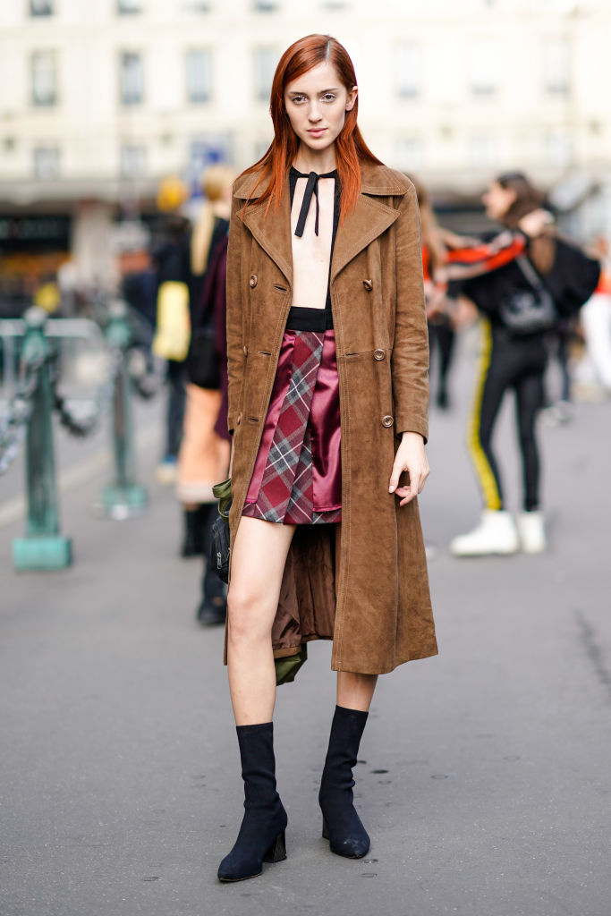 PARIS, FRANCE - SEPTEMBER 27: Teddy Quinlivan, model, wears a brown suede trench coat, outside the Dries Van Noten show, during Paris Fashion Week Womenswear Spring/Summer 2018, on September 27, 2017 in Paris, France. (Photo by Edward Berthelot/Getty Images)