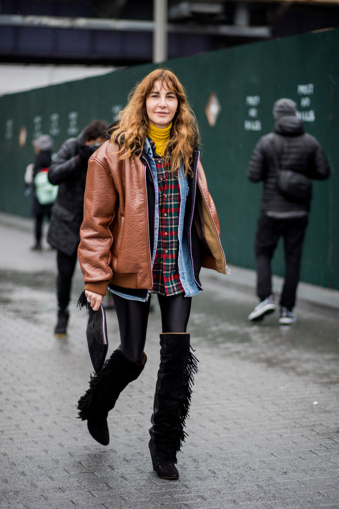 NEW YORK, NY - FEBRUARY 11: Ece Sukan wearing Supreme hoodie, brown leather jacket, plaid button shirt, black overknees with fringes seen outside Tibi on February 11, 2018 in New York City. (Photo by Christian Vierig/Getty Images)