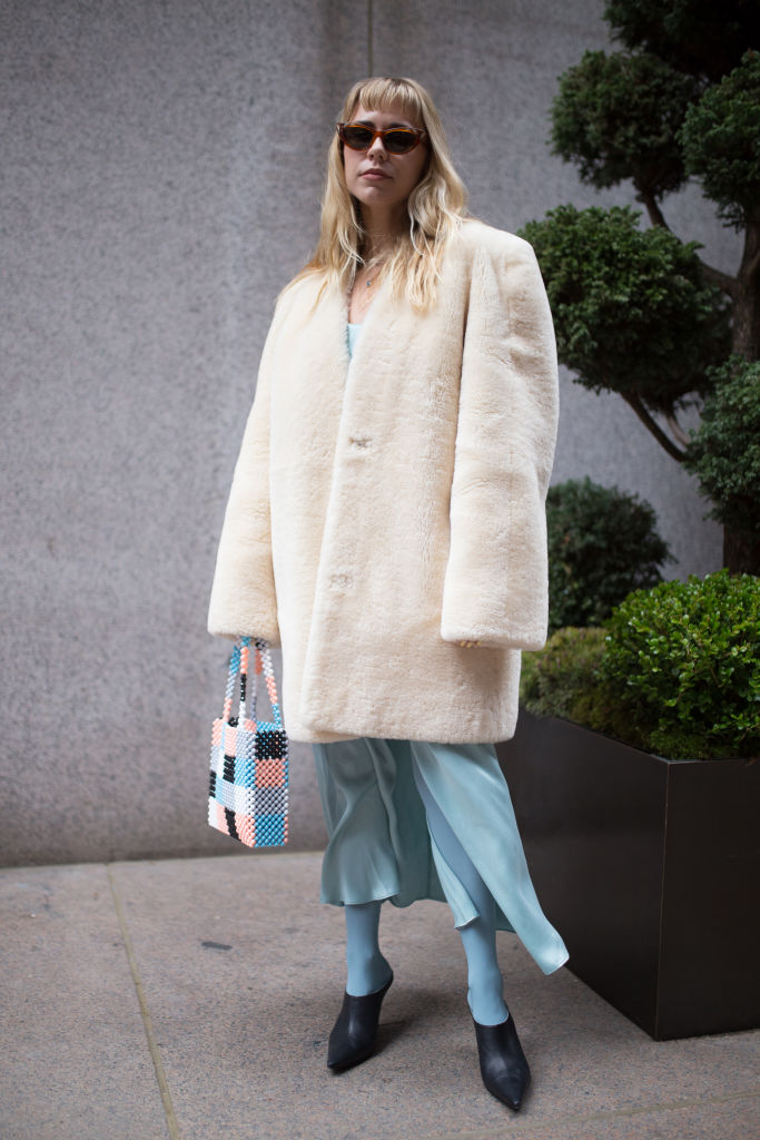 NEW YORK, NY - FEBRUARY 12: A guest is seen on the street attending Derek Lam during New York Fashion Week wearing a cream fur coat and baby blue skirt on February 12, 2018 in New York City. (Photo by Matthew Sperzel/Getty Images)