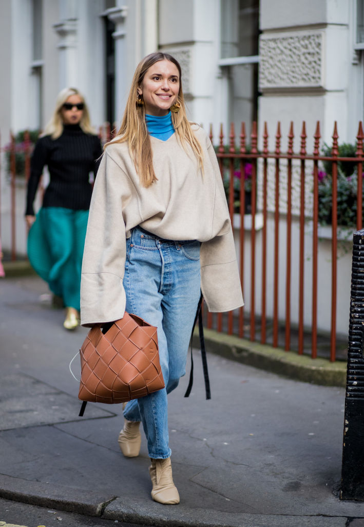LONDON, ENGLAND - FEBRUARY 16: Pernille Teisbaek wearing denim jeans blue turtleneck, creme white sweater with long sleeves seen, brown bag outside Mulberry during London Fashion Week February 2018 on February 16, 2018 in London, England. (Photo by Christian Vierig/Getty Images)
