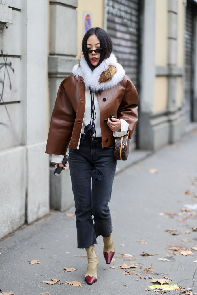 MILAN, ITALY - FEBRUARY 25: A guest wearing brown leather jacket, fur scarf, round Louis Vuitton bag is seen outside Marni during Milan Fashion Week Fall/Winter 2018/19 on February 25, 2018 in Milan, Italy. (Photo by Christian Vierig/Getty Images)