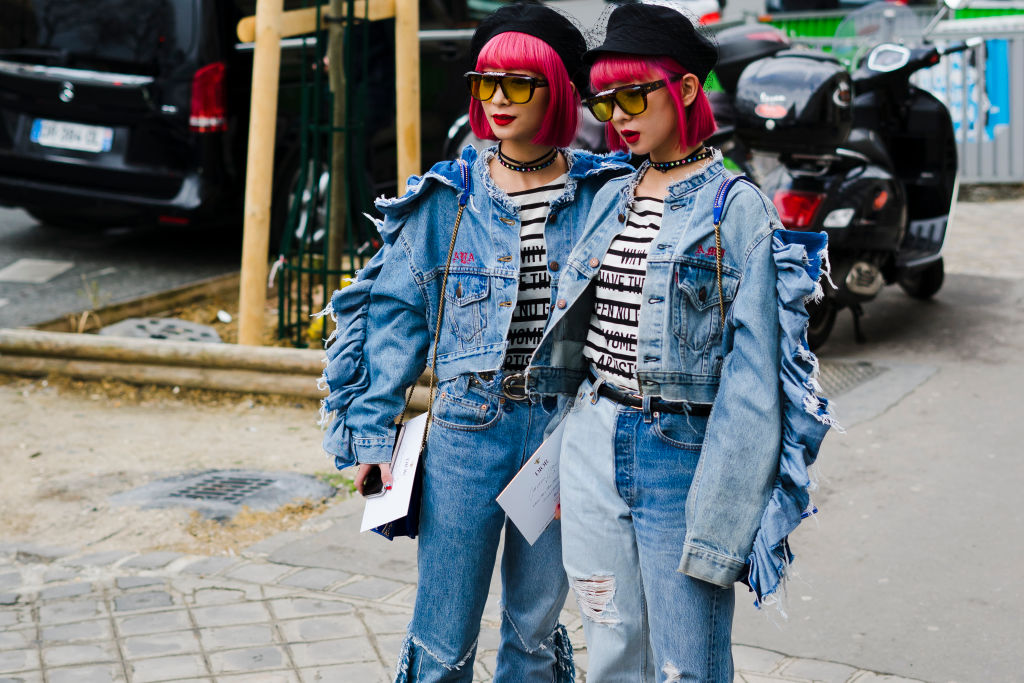 Twins Aya Amiaya, Little Lola Sunshine and Ami Amiaya wear denim tailleur, Dior blue bag and black hat in the streets of Paris before the Dior show during Paris Fashion Week Womenswear Fall/Winter 2018/2019 on February 27, 2018 in Paris, France. (Photo by Nataliya Petrova/NurPhoto via Getty Images)