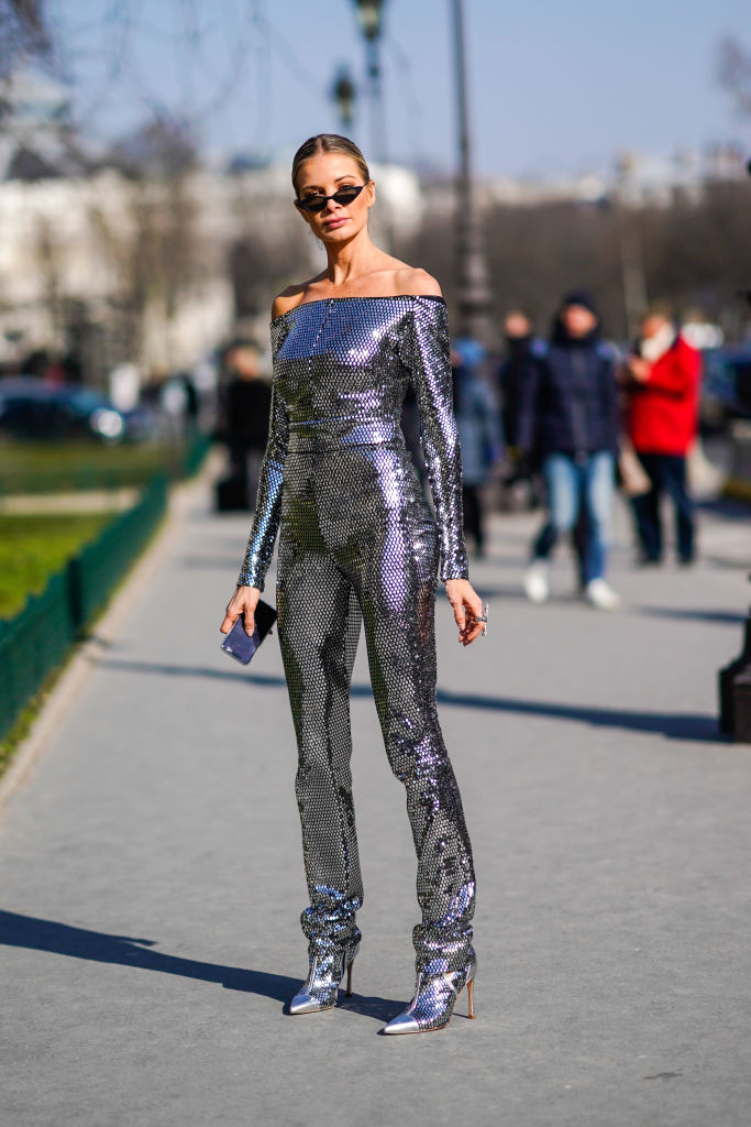 PARIS, FRANCE - FEBRUARY 28: A guest wears a silver shiny outfit and off-shoulder top, during Paris Fashion Week Womenswear Fall/Winter 2018/2019, on February 28, 2018 in Paris, France. (Photo by Edward Berthelot/Getty Images)