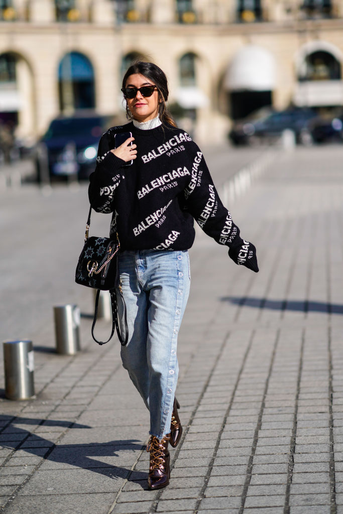 PARIS, FRANCE - FEBRUARY 28: Noa Souffir wears a Balenciaga top, flare jeans, a bag, sunglasses, during Paris Fashion Week Womenswear Fall/Winter 2018/2019, on February 28, 2018 in Paris, France. (Photo by Edward Berthelot/Getty Images)