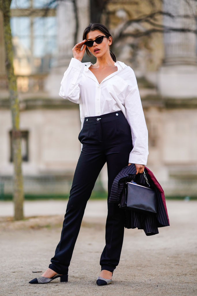 PARIS, FRANCE - MARCH 03: Georgia Fowler wears sunglasses, a white shirt, balck pants, a bag outside Elie Saab, during Paris Fashion Week Womenswear Fall/Winter 2018/2019, on March 3, 2018 in Paris, France. (Photo by Edward Berthelot/Getty Images)