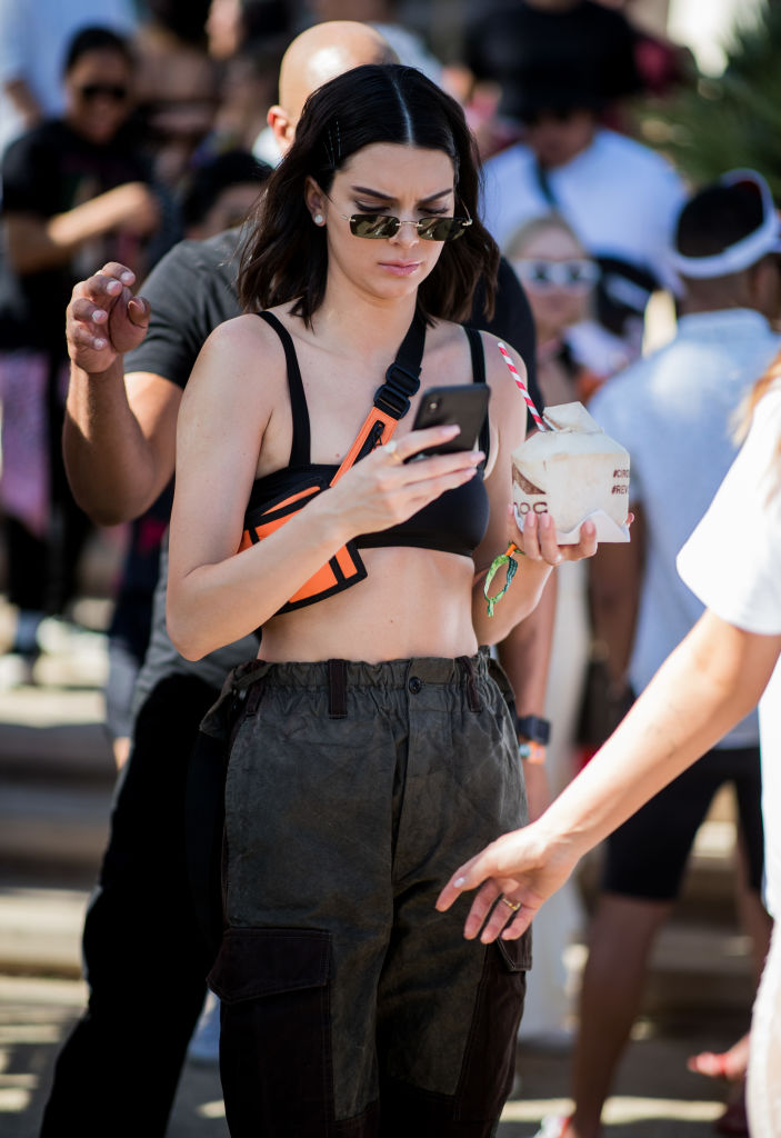 INDIO, CA - APRIL 14: Kendall Jenner wearing cropped top, belt bag, military pants is seen at Revolve Festival on April 14, 2018 in Indio, California. (Photo by Christian Vierig/GC Images)