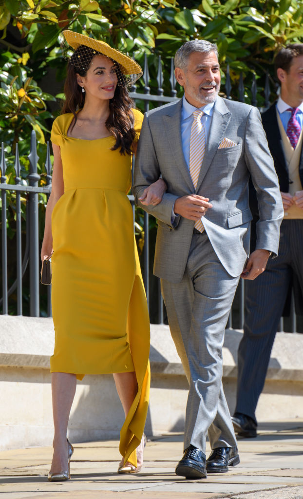 WINDSOR, ENGLAND - MAY 19: George Clooney and Amal Clooney attend the wedding of Prince Harry to Ms Meghan Markle at St George's Chapel, Windsor Castle on May 19, 2018 in Windsor, England. Prince Henry Charles Albert David of Wales marries Ms. Meghan Markle in a service at St George's Chapel inside the grounds of Windsor Castle. Among the guests were 2200 members of the public, the royal family and Ms. Markle's Mother Doria Ragland. (Photo by Pool/Samir Hussein/WireImage)
