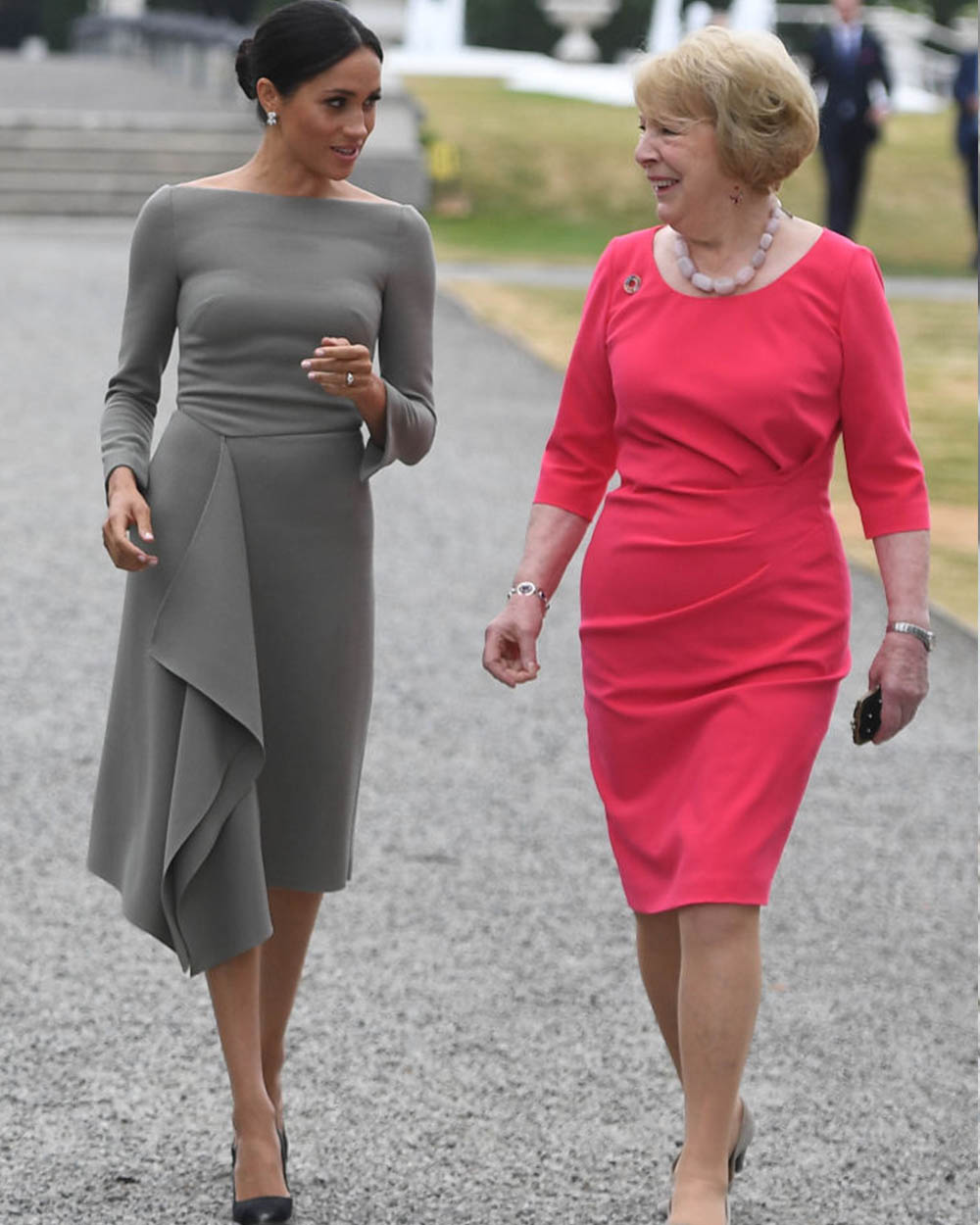 July 11, 2018: Continuing her whirlwind tour of Ireland, Meghan, Duchess of Sussex chats with Sabina Coyne, wife of the Irish President Michael Higgins wearing a grey Roland Mouret dress featuring a draped asymmetric skirt and -unsurprisingly -  a boatneck neckline.
