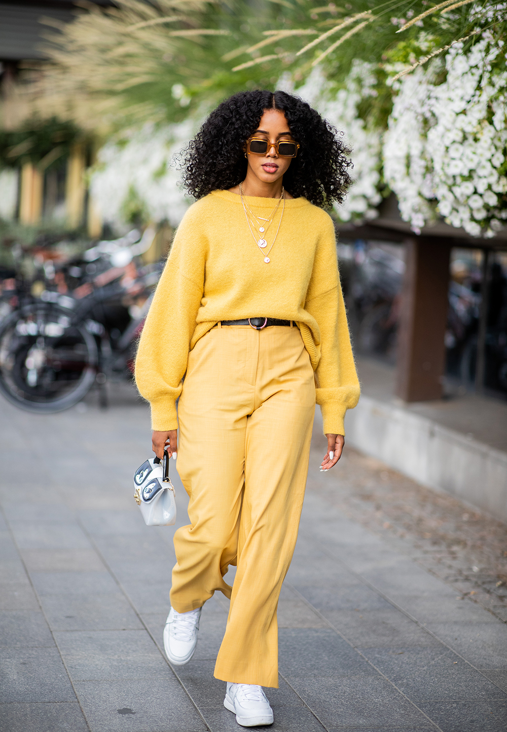 STOCKHOLM, SWEDEN - AUGUST 29: A guest wearing yellow knit and yellow pants, bag is seen during Stockholm Runway SS19 on August 29, 2018 in Stockholm, Sweden. (Photo by Christian Vierig/Getty Images)