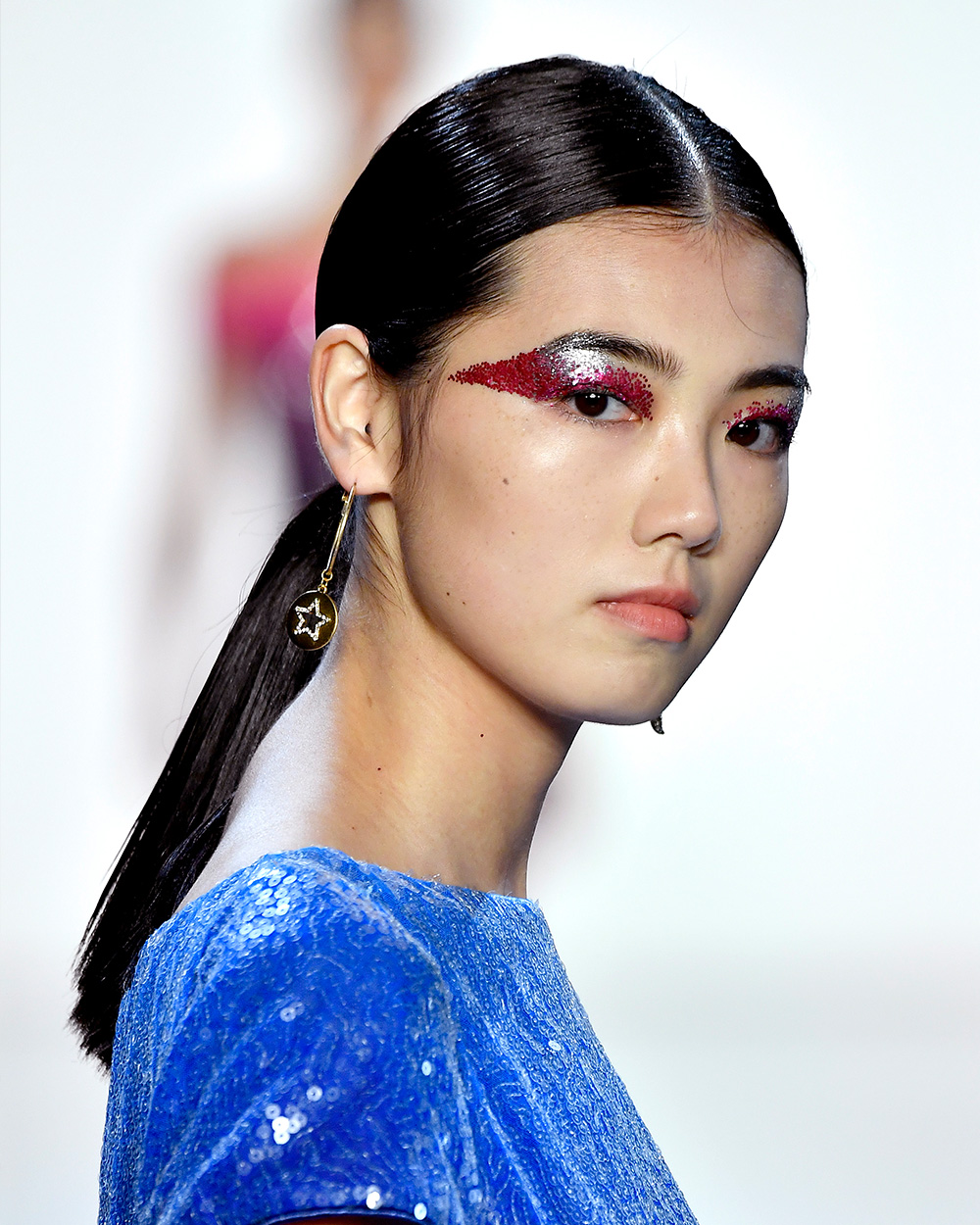 The best beauty looks from NYFW Tadashi Shoji Celestial-inspired hues of blue, silver, red and pink adorned the models' faces at Tadashi Shoji in the form of exaggerated winged eyeshadow.