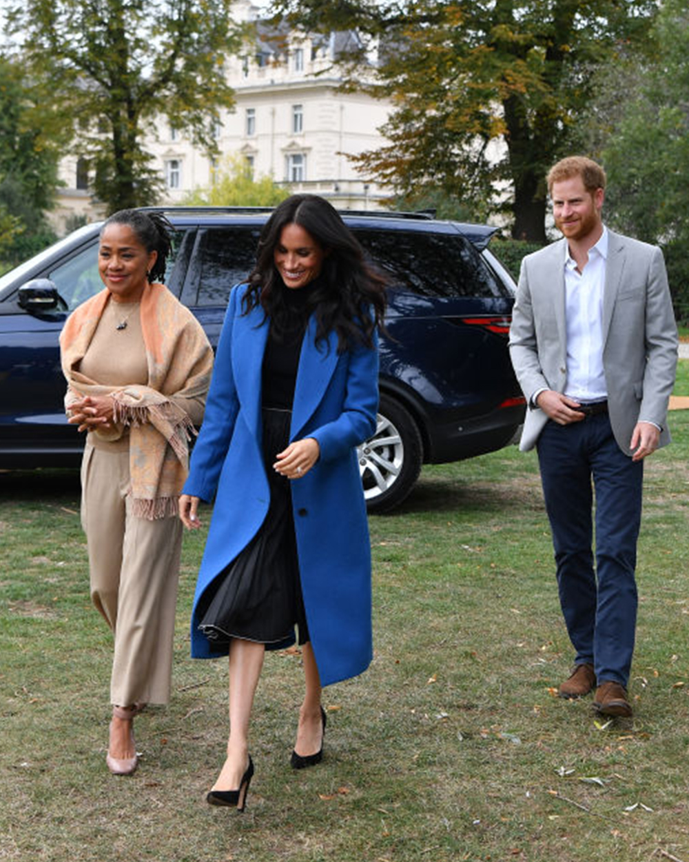 September 20, 2018: The Duchess of Sussex, her mother Doria and Prince Harry attend the launch of the cookbook she is supporting featuring recipes by women affected by the Grenfell Tower tragedy. Meghan wore a cobalt blue Smythe coat and a black pleated skirt by royal favourite (and BFF) Misha Nonoo. 