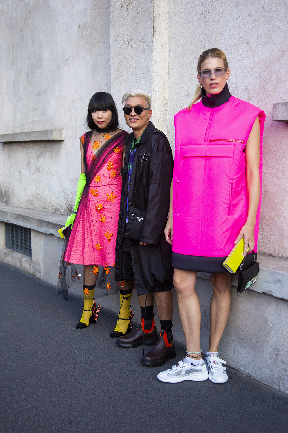 MILAN, ITALY - SEPTEMBER 20: Susanna Lau, wearing a neon fuchsia dress, Bryanboy and Veronika Heilbrunner, wearing a neon fuchsia jacket, are seen in the streets of Milano before the Prada show during Milan Fashion Week Spring/Summer 2019 on September 20, 2018 in Milan, Italy. (Photo by Claudio Lavenia/Getty Images)