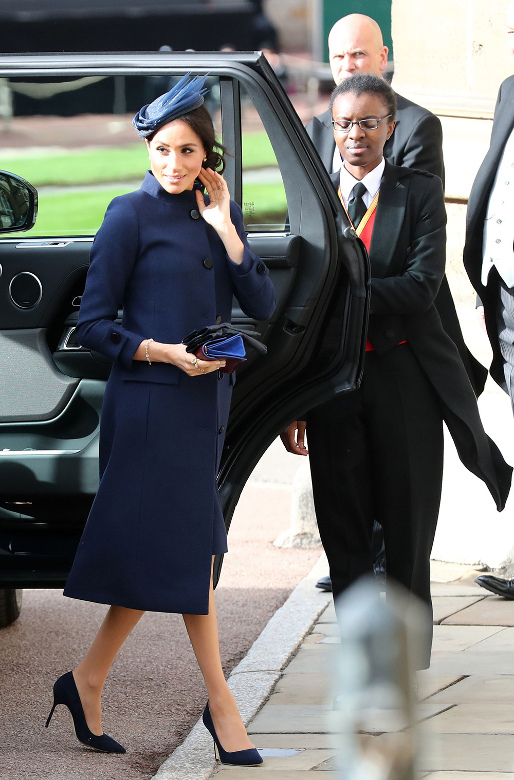 October 12, 2018: Five months following her wedding to Prince Harry, Meghan, Duchess of Sussex arrives at the same venue in the same designer to attend the nuptials of Princess Eugenie and Jack Brooksbank. The regal navy look by Givenchy wasn't short on modern Meghan's style, however. Teaming it with a hat by Noel Stewart and a cluster of unusually heavy gold rings on her right hand by Pippa Small, the Duchess has caused a sell out for the ethical designer. 