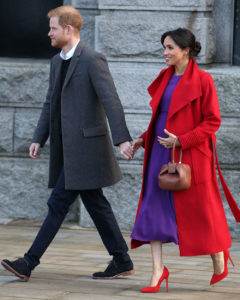 January 14, 2019: Meghan Markle and Prince Harry join forces for their day-long visit to Birkenhead, to support local communities. Today, Meghan wore a bright red Sentaler coat over a purple Babaton by Aritizia dress with red Stuart Weitzman heels Gabriela Hearst bag.
