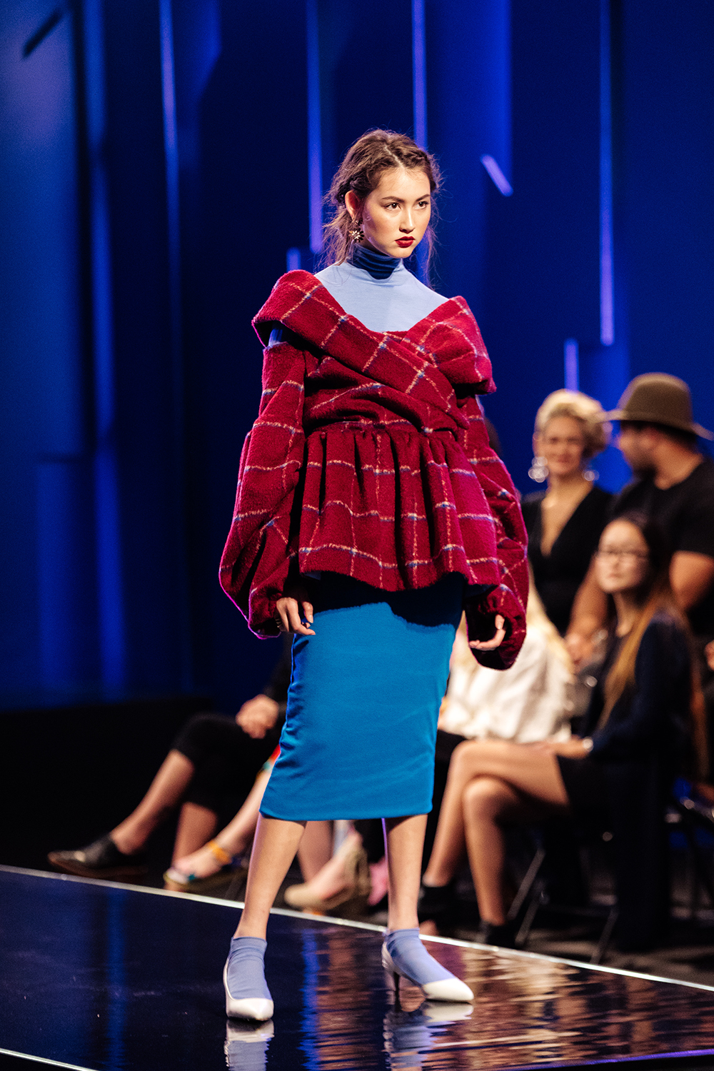 Jess Resene wallpaper: A carpet bag upholstery floral. Design: a cornflour blue merino turtleneck with matching crew sock, dark blue pencil skirt just over the knee in length and a thick tartan off the shoulder jacket with a full sleeve and gathering through the waist. Jess wanted to evoke a sense of warmth and cosiness, much like her wallpaper. Judges comments: