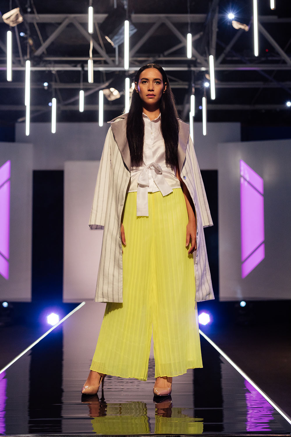 Kerry Neon yellow sweetheart dress with pleated chiffon skirt (which formed the basis of his wide-legged trousers), sleeveless white collared shirt with tie through the waist, white pinstripe coat with silver lapel. Judges’ comments: Sally-Ann: “This missed the mark…I don’t know about the tie-front waist, I wished you’d done something a little more fashion forward on the top half.” Robert: “You could have been more innovative with the colour choice” Benny: “It’s pedestrian.” Georgia: “When you’ve got something this crazy, why not play it up rather than tone it down?”