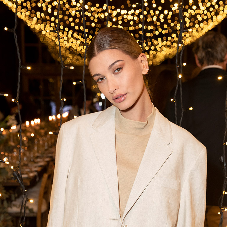 November 2018: Hailey attends the bareMinerals' Global Wellness Retreat at Soho Farmhouse in England wearing her hair slicked back into low knot with minimal jewellery for a clean polished look.  Perfect for: Looking polished and sharp when you probably feel like crap. 