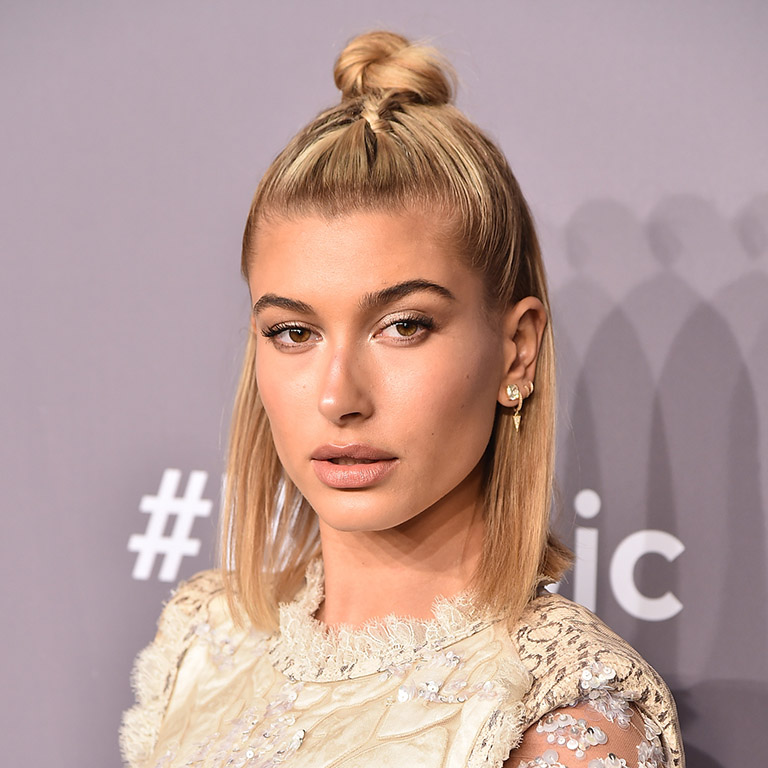 February 2018: Hailey takes the half-up-half-down top knot into format territory by wearing this semi-braided style to the amfAR Gala in New York City.  Perfect for: Days when you want the benefits of a face lift without the severity of an up-do. 