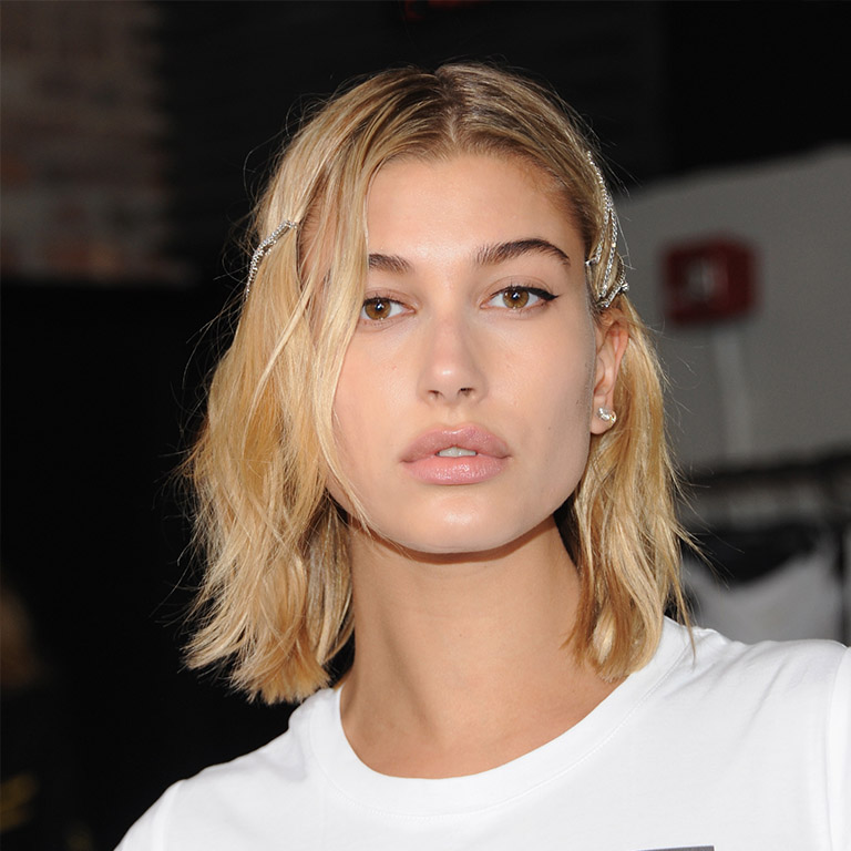 February 2018: Backstage at Zadig & Voltaire's fashion show during New York fashion week, Hailey makes a case for the disorderly tousles secured back with glam diamond encrusted hair pins. Perfect for: Feeling edgy, sexy and beautiful when you can't book into the salon for a trim because you're a) broke, b) disorganised, or c) all of the above.