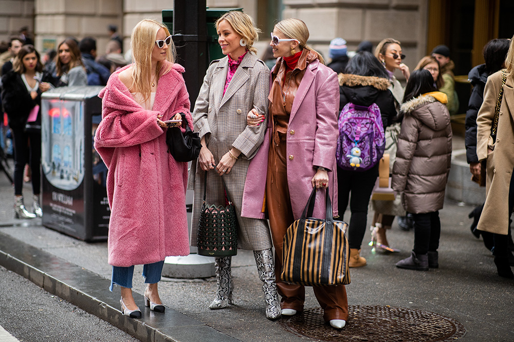 NEW YORK, NEW YORK - FEBRUARY 08: Charlotte Groeneveld is seen wearing pink teddy coat, Mary Lawless Lee and a guest wearing brown leather pants outside Kate Spade during New York Fashion Week Autumn Winter 2019 on February 08, 2019 in New York City. (Photo by Christian Vierig/Getty Images)