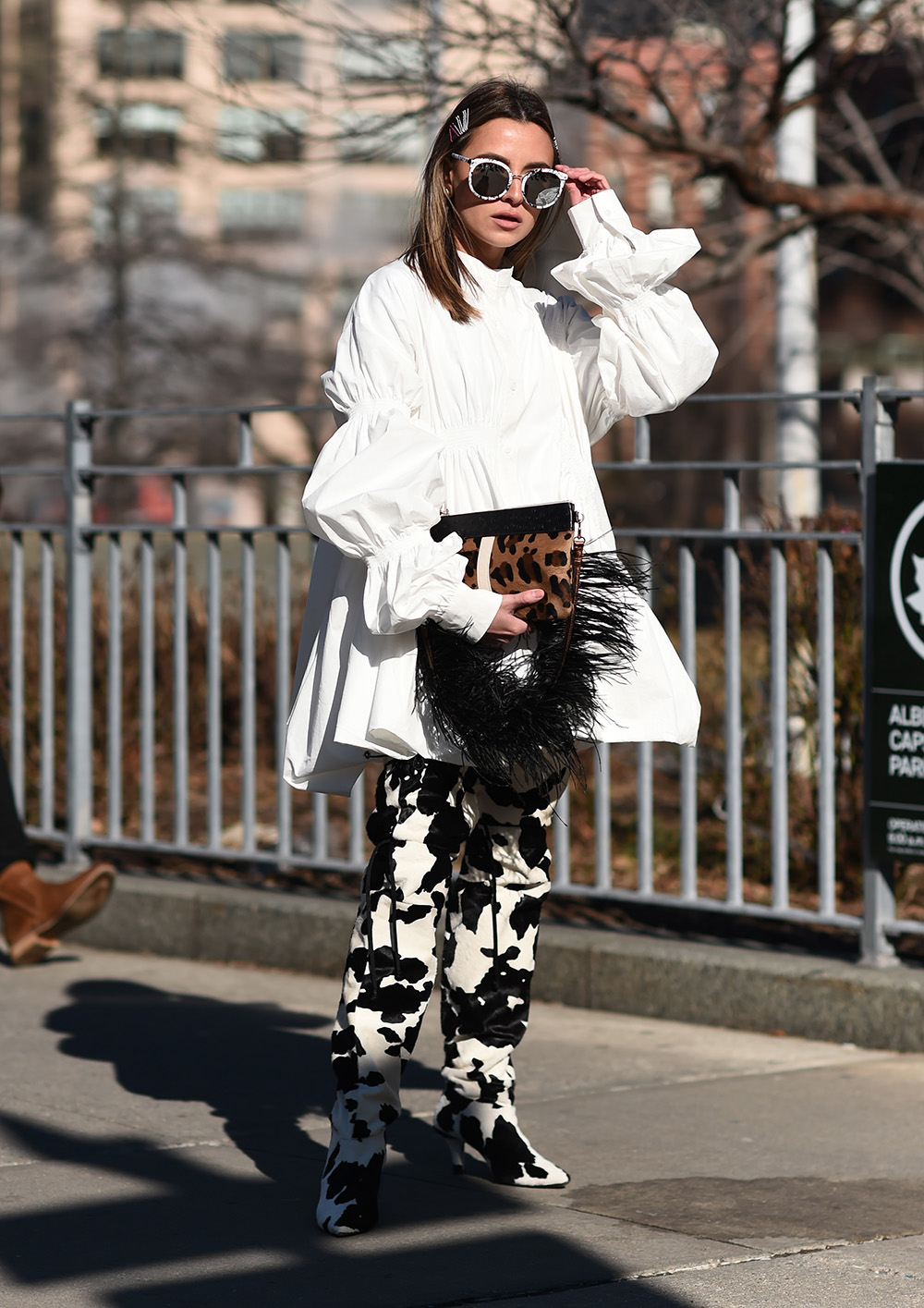 NEW YORK, NEW YORK - FEBRUARY 09: A guest is seen wearing a white top and black and white pants with an animal print fur purse outside the Son Jung Wan show during New York Fashion Week: Fall/Winter 2019 on February 09, 2019 in New York City. (Photo by Daniel Zuchnik/Getty Images)