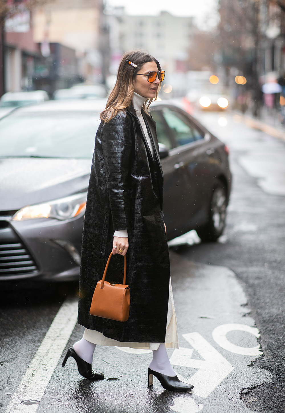 NEW YORK, NEW YORK - FEBRUARY 08: A guest is seen wearing black coat, turtleneck, brown bag, hair clip outside Nanushka during New York Fashion Week Autumn Winter 2019 on February 08, 2019 in New York City. (Photo by Christian Vierig/Getty Images)