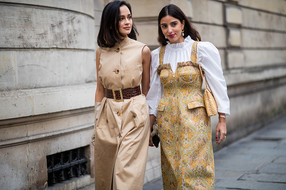 PARIS, FRANCE - MARCH 02: Anna Rosa Vitello is seen wearing beige sleeveless dress, gloves and Bettina Looney wearing golden dress, white blouse outside Elie Saab during Paris Fashion Week Womenswear Fall/Winter 2019/2020 on March 02, 2019 in Paris, France. (Photo by Christian Vierig/Getty Images)