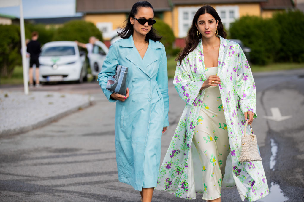 COPENHAGEN, DENMARK - AUGUST 08: Anna Rosa Vitiello seen wearing turquois coat and Bettina Looney wearing coat with floral print, dress outside Stine Goya during Copenhagen Fashion Week Spring/Summer 2020 on August 08, 2019 in Copenhagen, Denmark. (Photo by Christian Vierig/Getty Images)