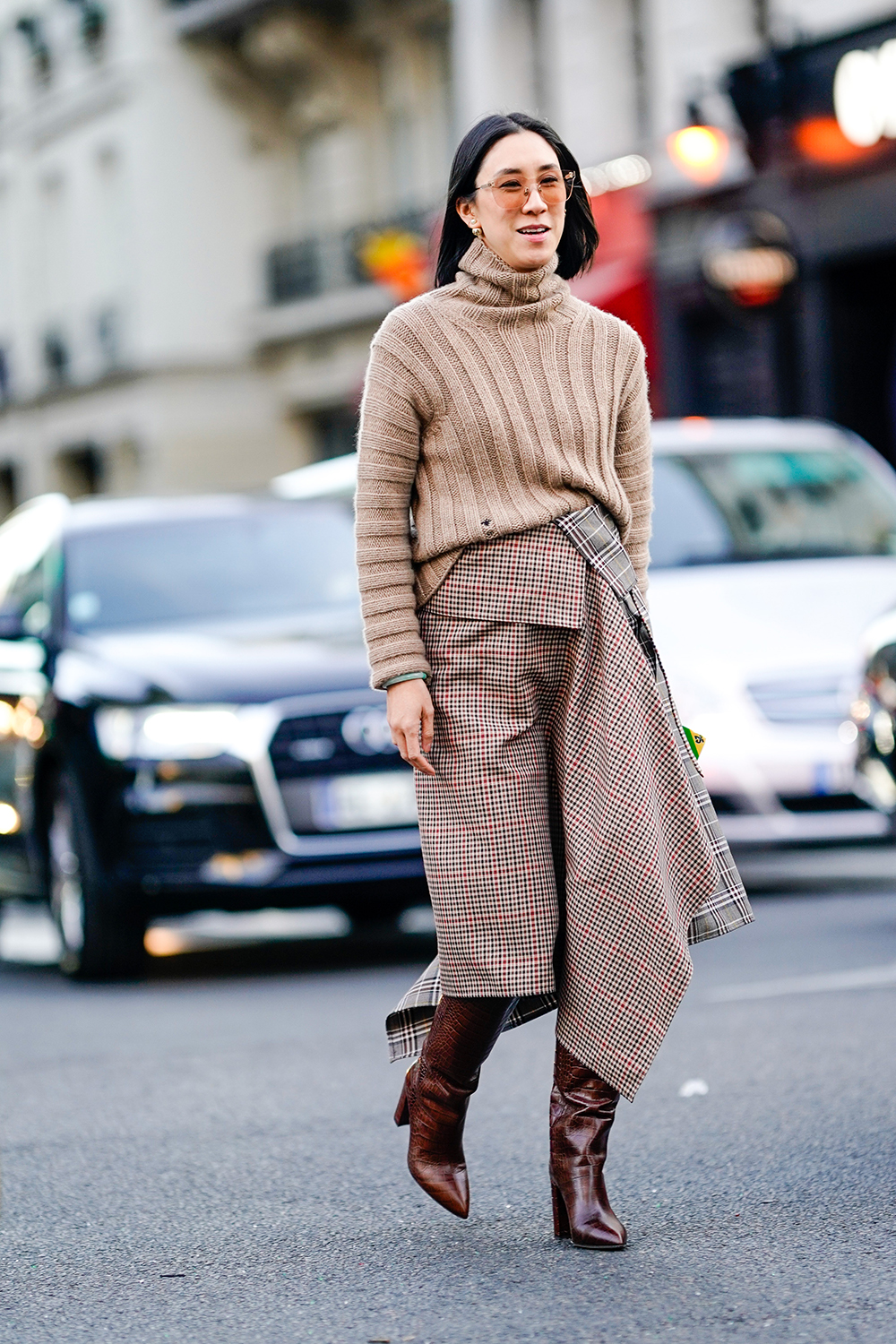 PARIS, FRANCE - SEPTEMBER 24: Eva Chen wears a brown wool turtleneck pullover, a checked printed skirt, brown leather boots, outside Gucci, during Paris Fashion Week Womenswear Spring/Summer 2019, on September 24, 2018 in Paris, France. (Photo by Edward Berthelot/Getty Images)