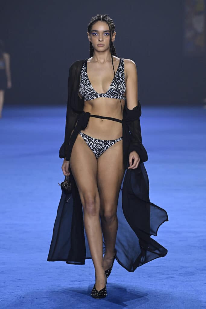 SYDNEY, AUSTRALIA - MAY 16: A model walks the runway in a design by Irrah Swim during the David Jones Indigenous Fashion Projects show during Australian Fashion Week Presented By Pandora 2024 at Carriageworks on May 16, 2024 in Sydney, Australia. (Photo by Stefan Gosatti/Getty Images for AFW)