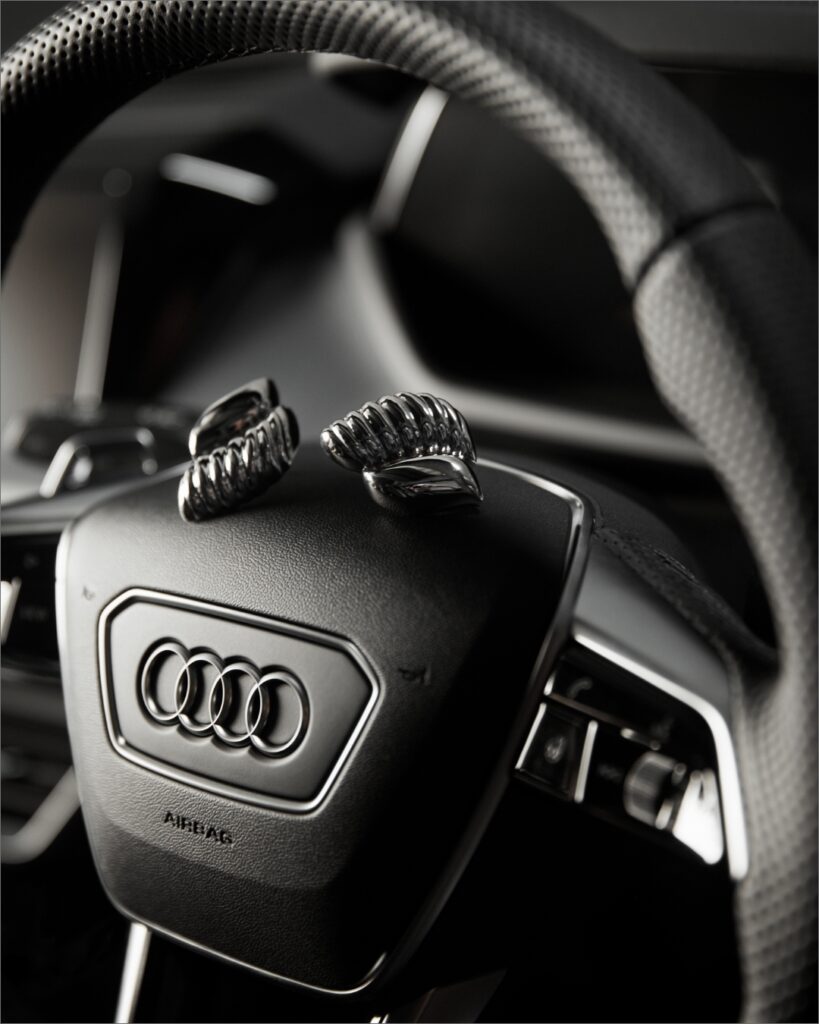 Detailed shot of the Audi RS e-tron GT's interior juxtaposed with designer accessories, highlighting the blend of technology and style.