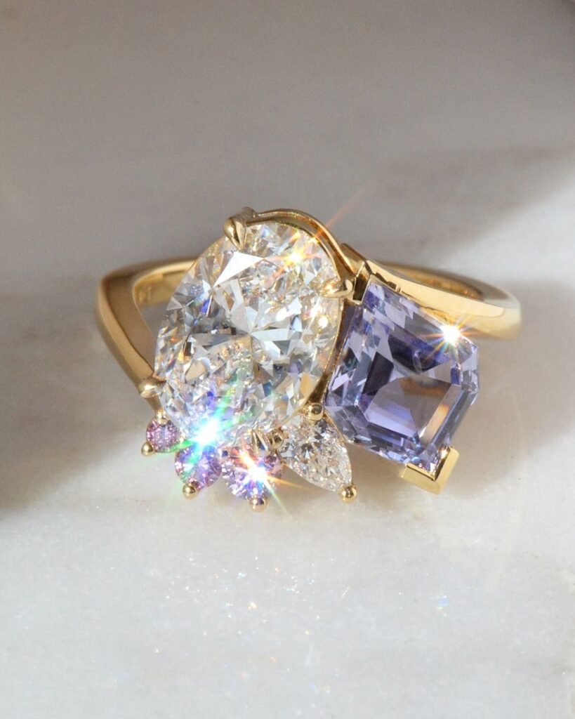 This bespoke design features a 2.01ct GIA certified Type 2A, internally flawless, D colour oval cut diamond, set alongside a custom kite cut lavender sapphire in a Toi et Moi layout, accented by a trail of Argyle pink diamonds, selected with different saturations to create a pink ombré, POA.