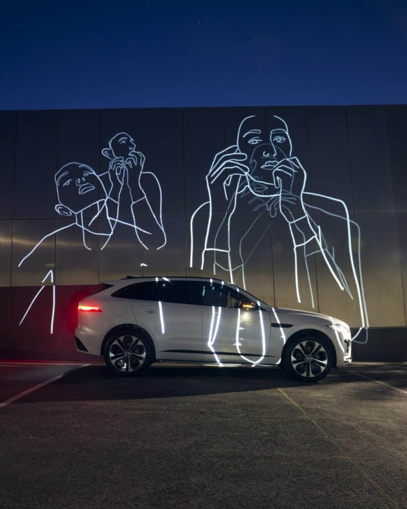 Artist Holly Schroder creating a light installation, blending projections to reflect on the fluid nature of memory.