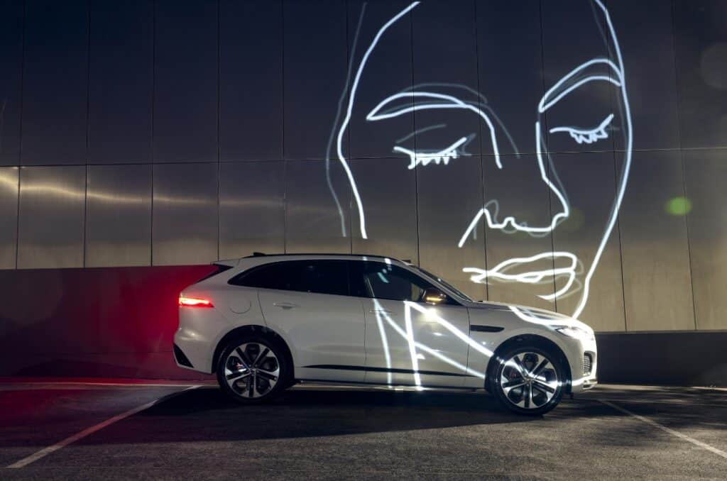 Artist Holly Schroder creating a light installation, blending projections to reflect on the fluid nature of memory.