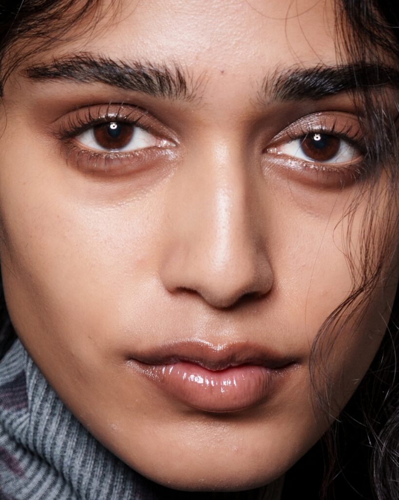 A model backstage at Erdem's autumn/winter 2026 show, captured in a close-up beauty shot featuring the collection's signature soft, refined makeup look.