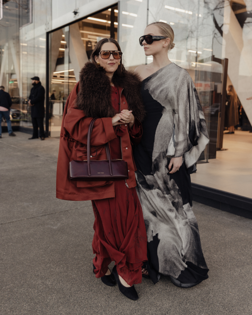 Sarah Murray and Georgia Bramley at the New Zealand Fashion Week 2026 opening show wearing Harris Tapper and Rory William Docherty.